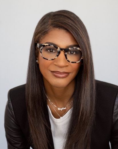 Black woman with glasses and a black blazer
